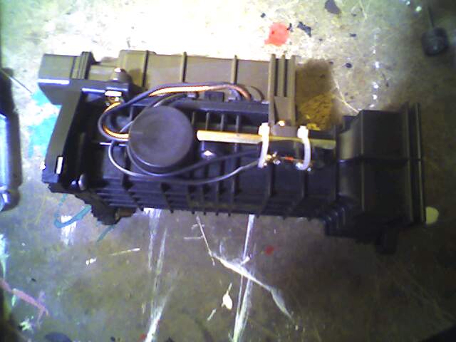 Side of the metering unit, lower non-metering section removed. The thing ziptied to the side is the intake air temp sensor.